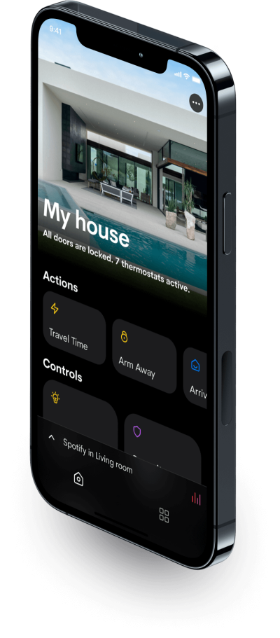 A smartphone displaying the Crestron Home interface with various home automation controls, showing a modern home with a pool in the background.