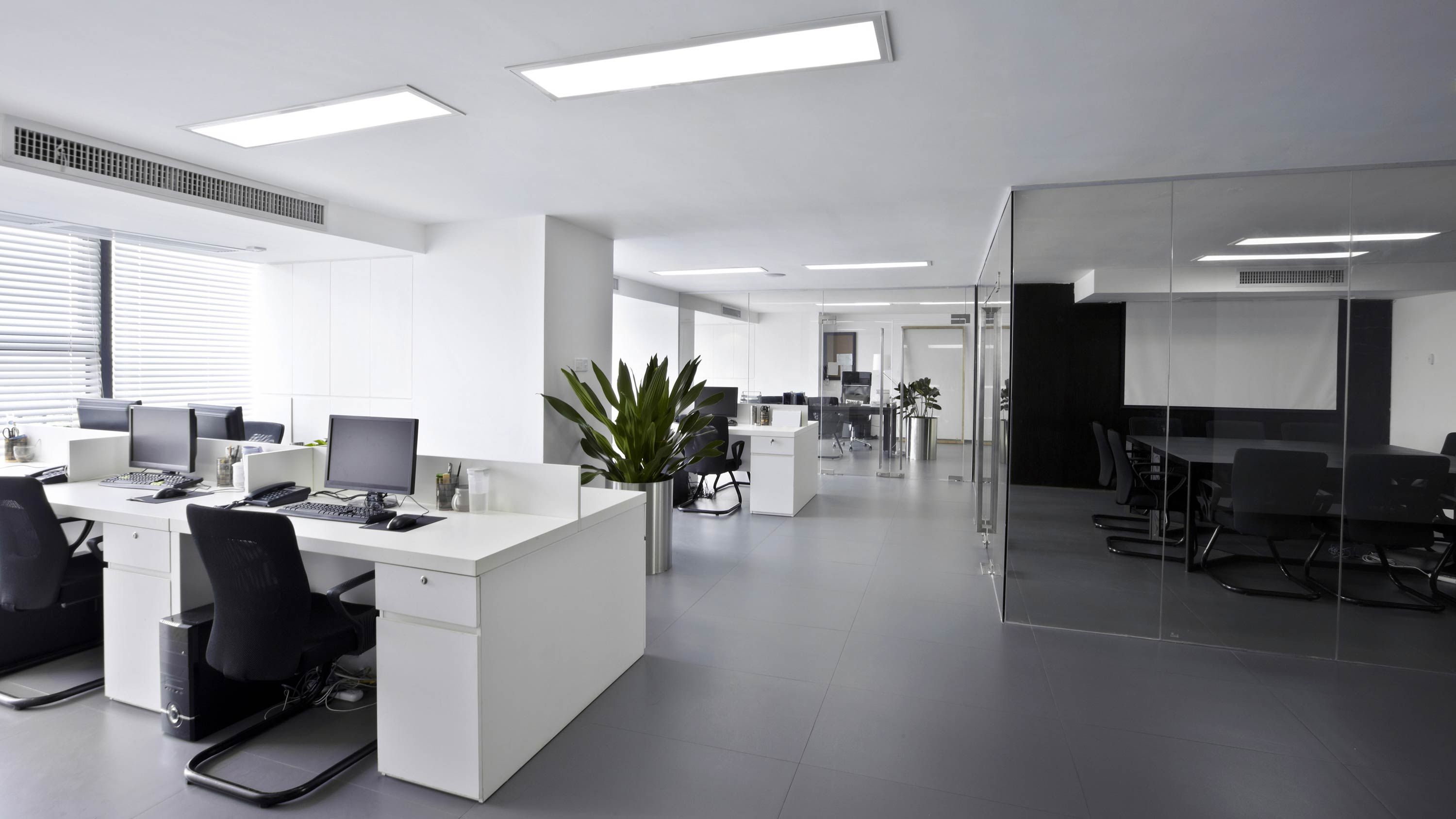 professional office with white furniture and skylights