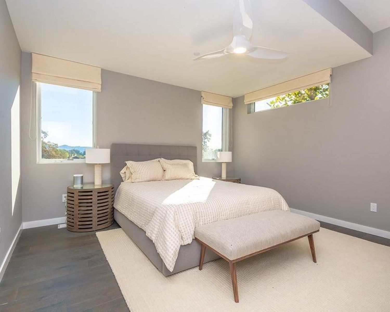 grey bedroom with lutron window treatments